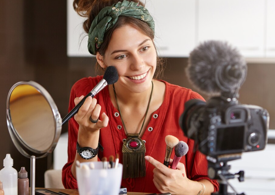 Female vlogger filming makeup video